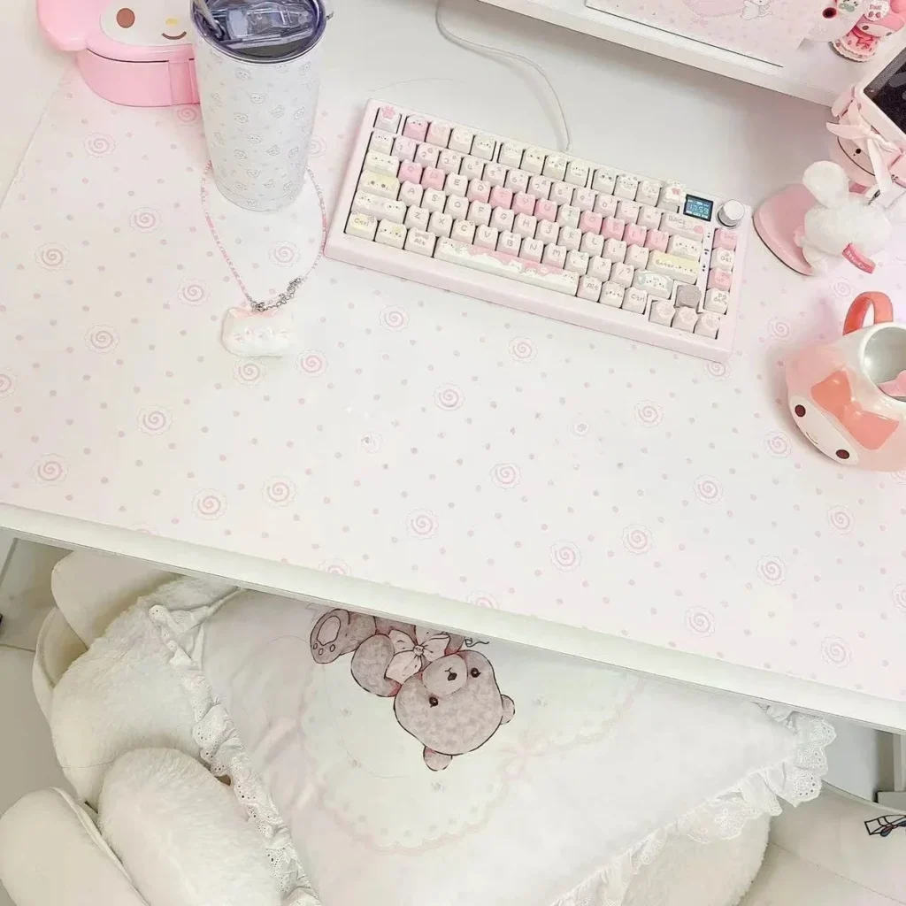 Fish Cake Desk Mat on a white desktop, showcasing pink and white colors.