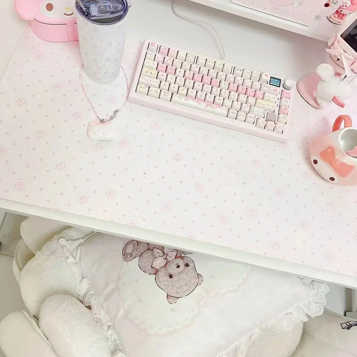 Fish Cake Desk Mat on a white desktop, showcasing pink and white colors.