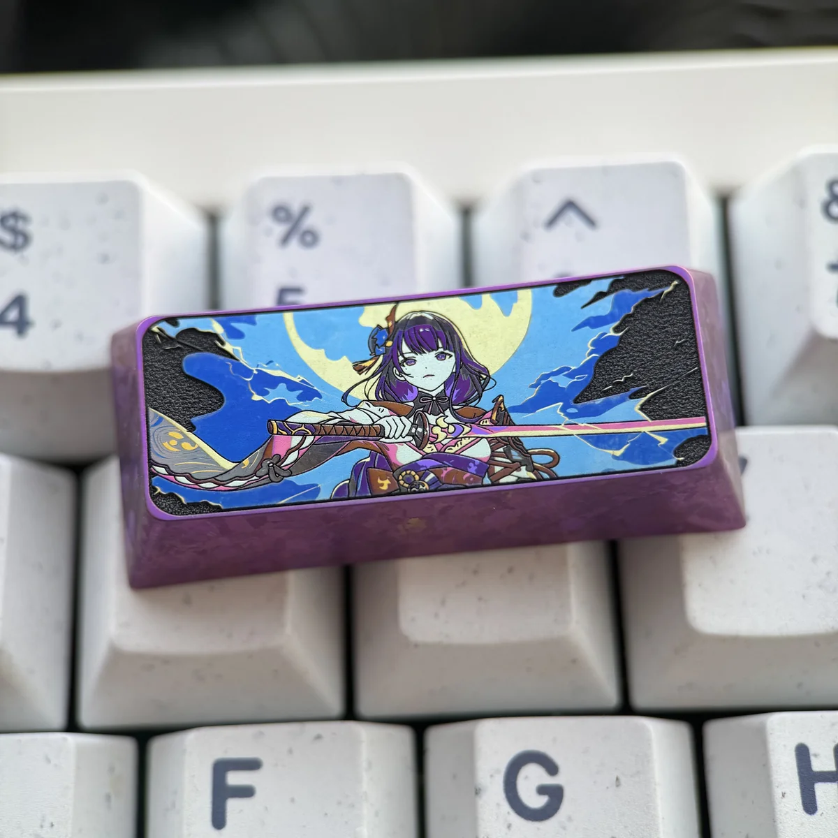 Artistic shot of the Raiden Shogun titanium keycap, emphasizing its collectible quality and Genshin Impact theme