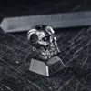 Terminator T-800 keycap in hand, highlighting size and texture