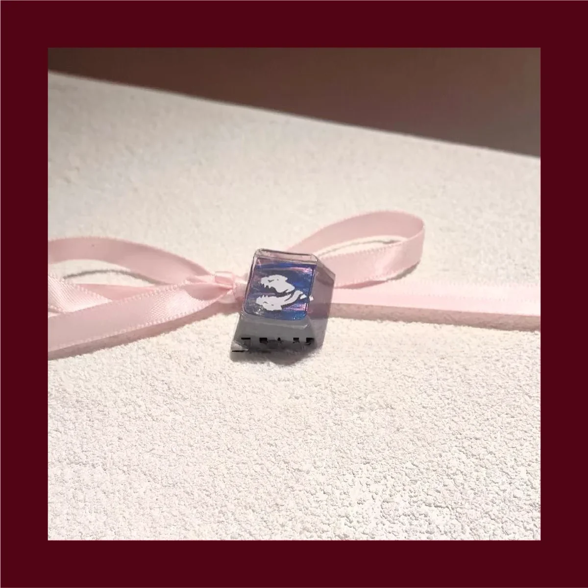 Close-up, angled view of the artisan Fade Prowler keycap, emphasizing its intricate texture and resin finish.