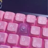 Artisan's hand holding the Valorant Reyna keycap, highlighting its unique craft