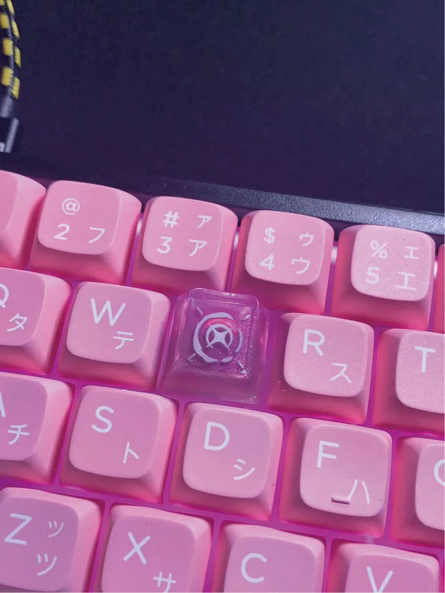 Artisan's hand holding the Valorant Reyna keycap, highlighting its unique craft