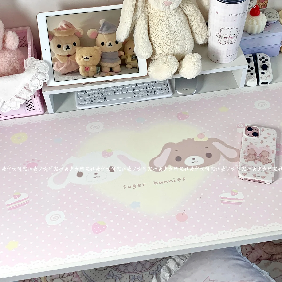 Close-up of the pastel pink and white Sugarbunnies design on the desk mat, showing Kurousa and Shirousa