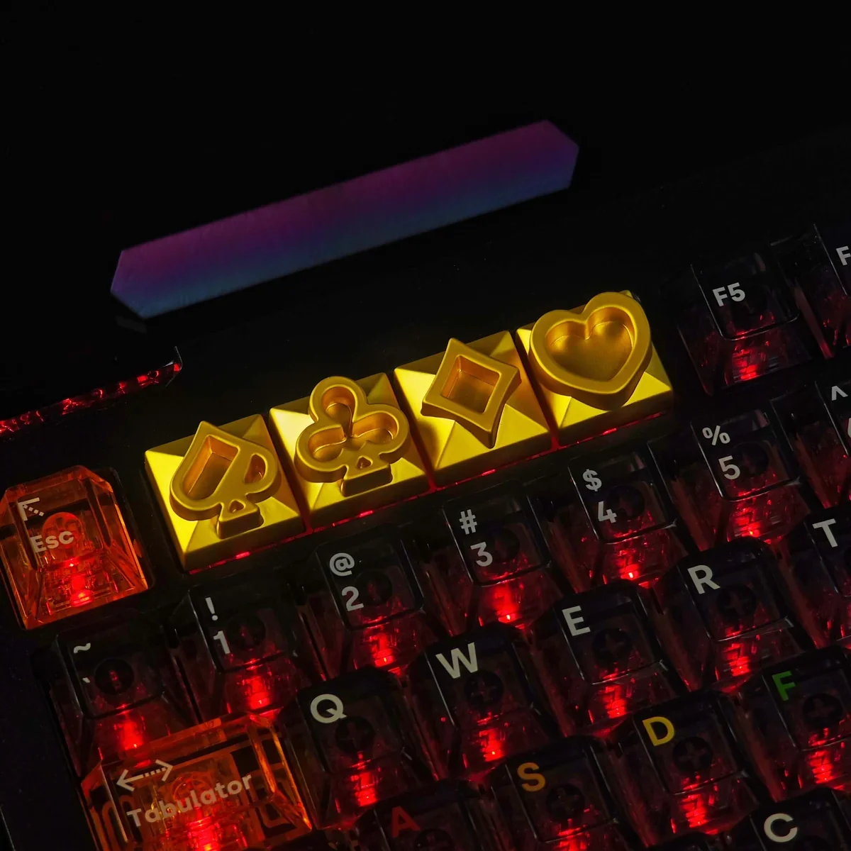 Macro shot of the laser-engraved poker suit details on the artisan keycap.