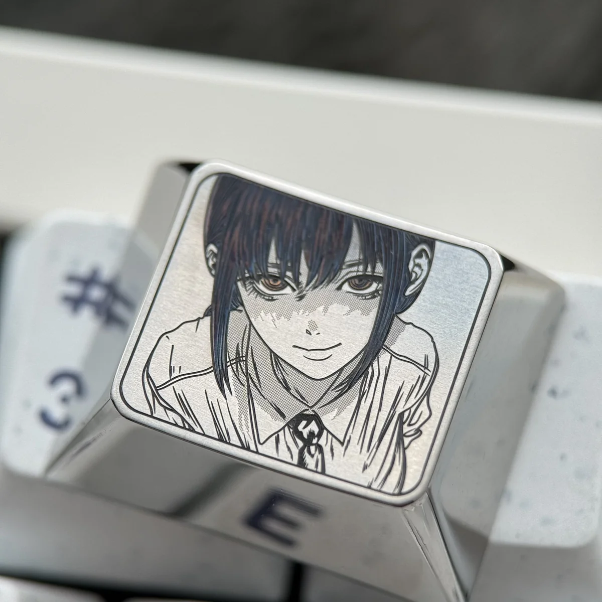 Close-up of Makima Titanium Keycap's CNC-machined details and engraved character art