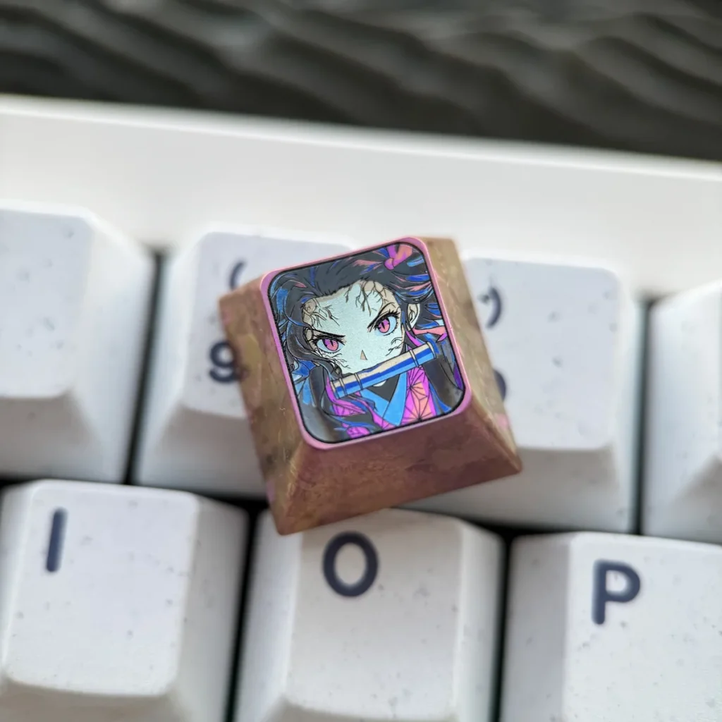 Nezuko Kamado artisan keycap handcrafted from titanium, showcasing intricate details on a mechanical keyboard.