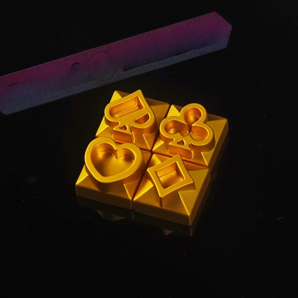 Close-up of Poker Suits Metal Keycap on a mechanical keyboard, showing heart, diamond, club, and spade engravings.