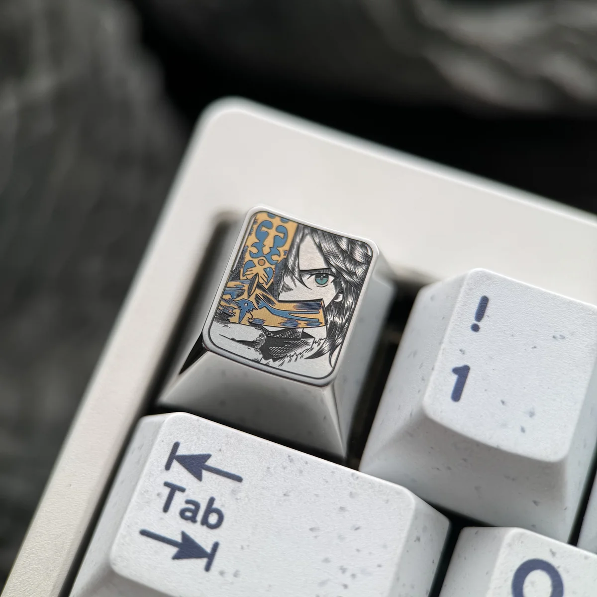 Hand holding Saber titanium ESC keycap, demonstrating premium feel