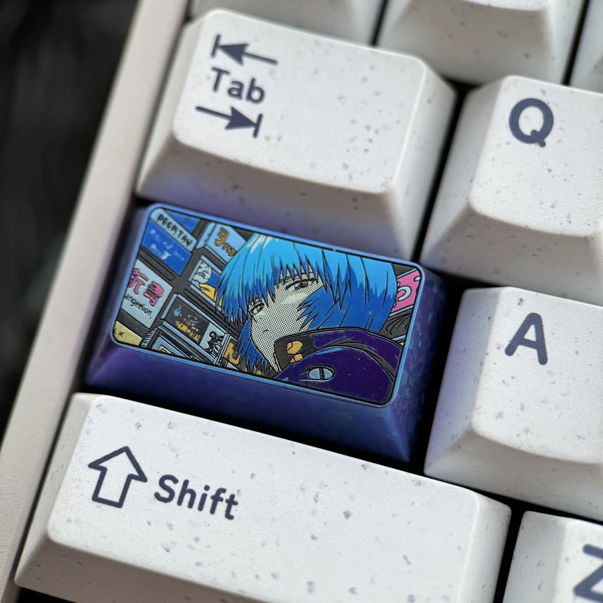 Close-up of Rei Ayanami keycap showcasing metallic finish and detail