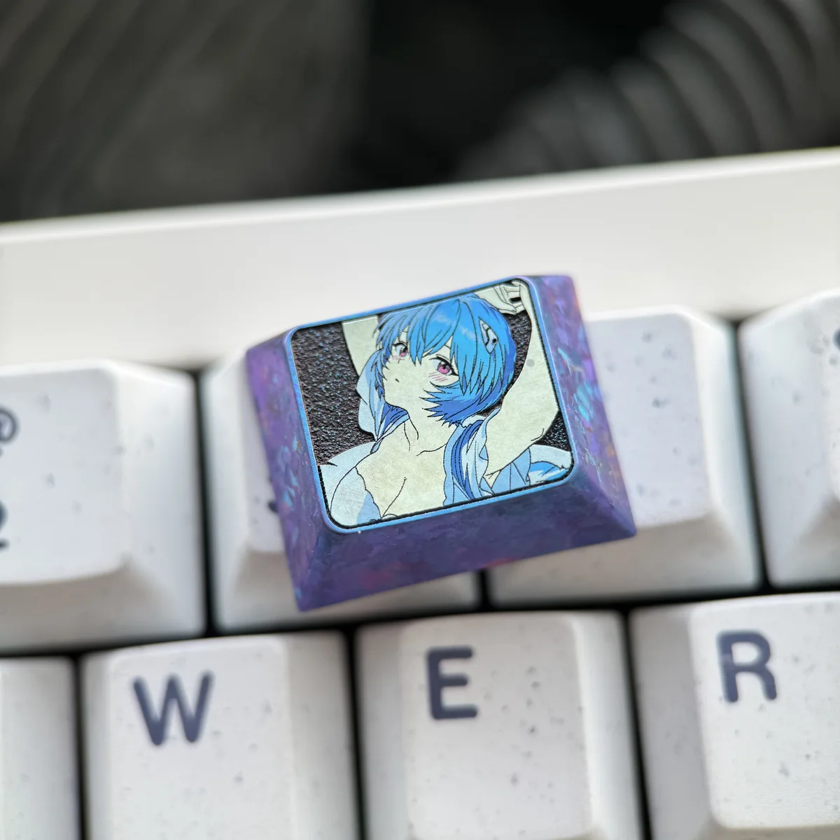 Rei Ayanami titanium keycap integrated into a themed Evangelion keyboard setup.