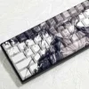Close-up of Straw Hat keycaps showcasing side-engraved legends and backlighting