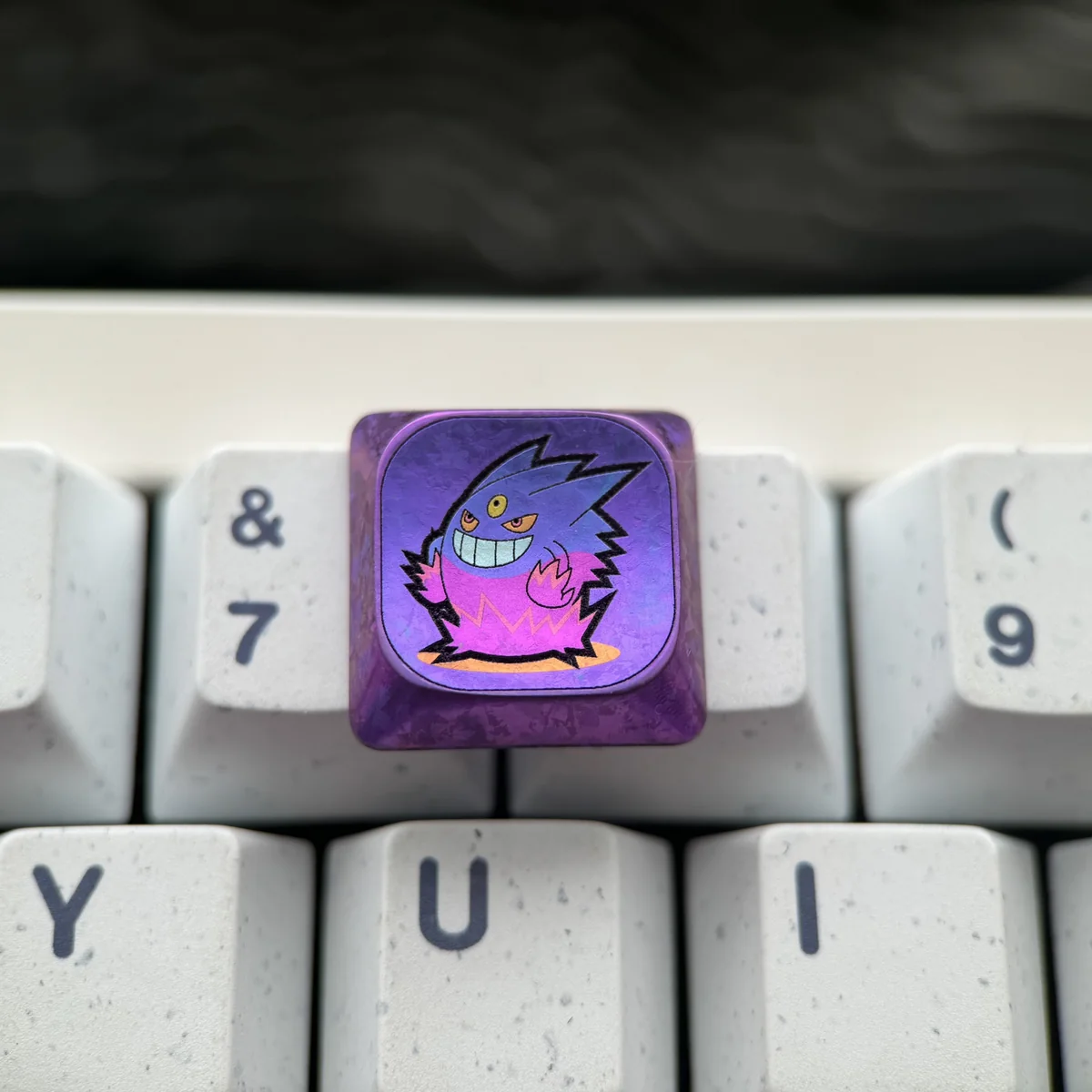 Collection of Gengar titanium keycap from different angles, showcasing craftsmanship