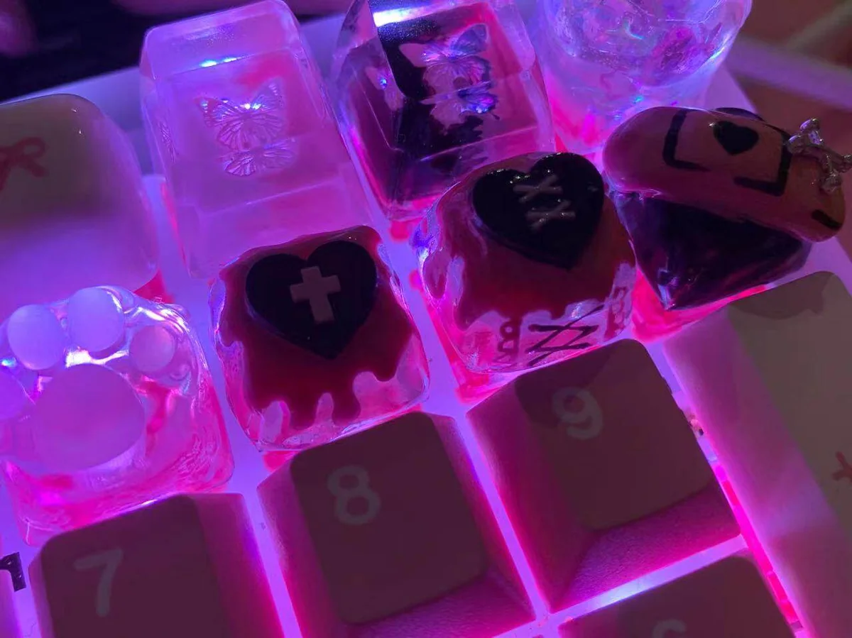 Close-up of a handcrafted resin blackberry cookie keycap with intricate details