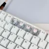 Hand holding a single Pink Butterfly Heart keycap, showcasing the delicate craftsmanship and vibrant pink hues
