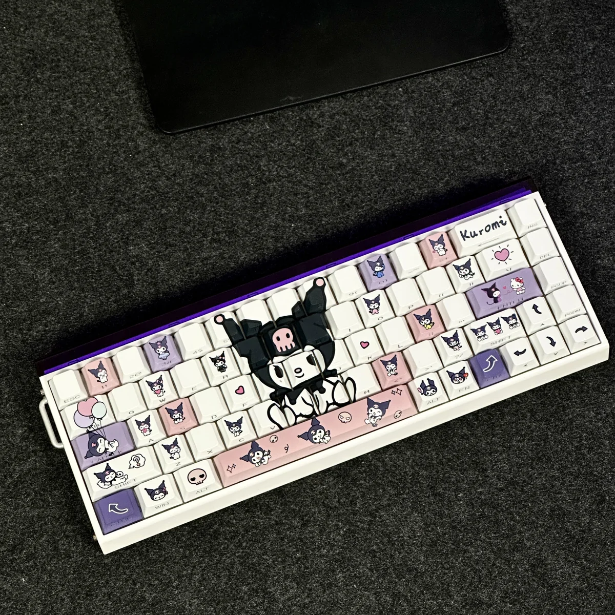 Full view of a keyboard adorned with the dark-cute Kuromi Keycap Set, glowing with backlight