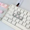 Close-up of Pink Butterfly Heart artisan keycaps on a mechanical keyboard, showing intricate 3D detail