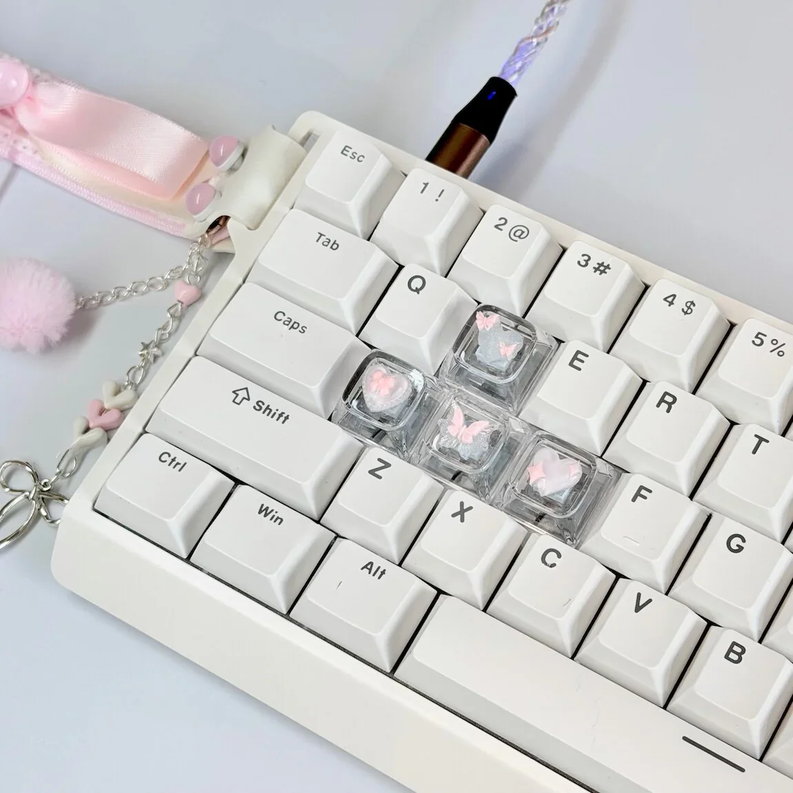 Close-up of Pink Butterfly Heart artisan keycaps on a mechanical keyboard, showing intricate 3D detail