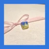 Transparent resin Valorant Neon keycap from an isometric view, emphasizing its unique shape and R4 profile.