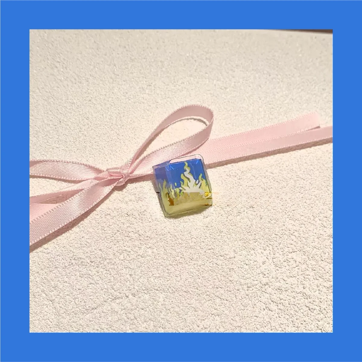 Transparent resin Valorant Neon keycap from an isometric view, emphasizing its unique shape and R4 profile.