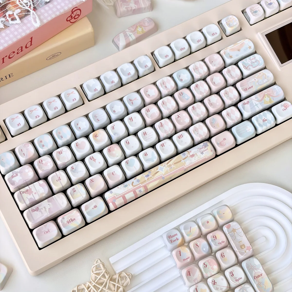 Dreamy pastel pink and purple keycaps with unique novelty designs for mechanical keyboards
