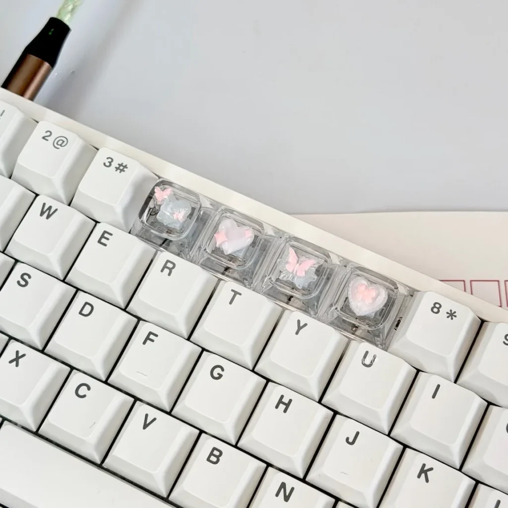 Side view of XDA profile Pink Butterfly Heart keycaps, highlighting uniform height and transparent resin