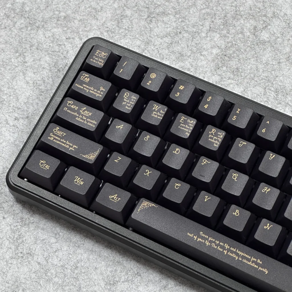 Close-up detail of the intricate black and gold Baroque pattern on a PBT keycap, highlighting dye-sublimation quality.