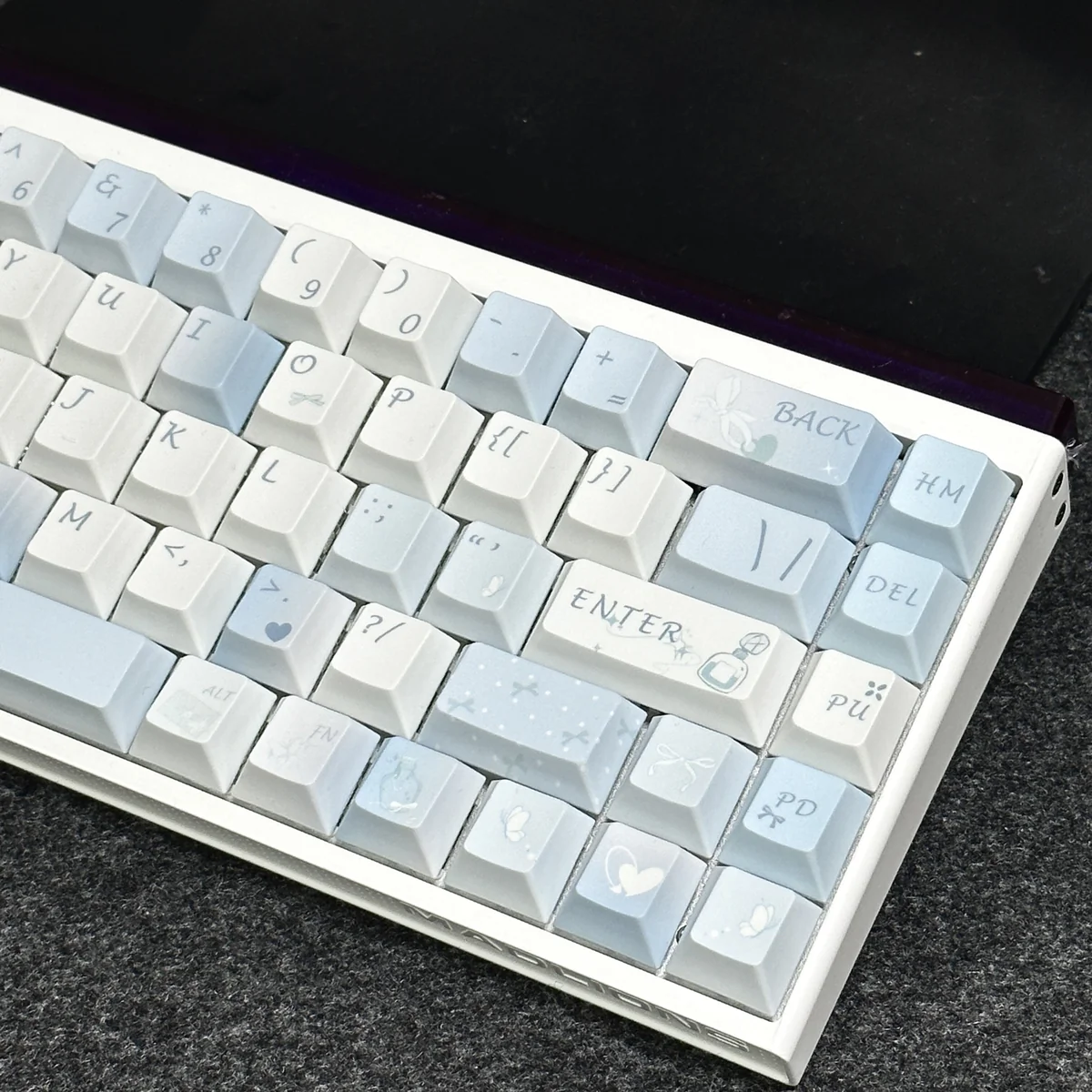 Detail shot of a single Blue Melody keycap, emphasizing PBT material and dye-sublimated legend quality.