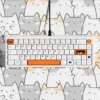 A keyboard equipped with the Calico Cat Keycap Set, set in a whimsical, comforting desk environment.
