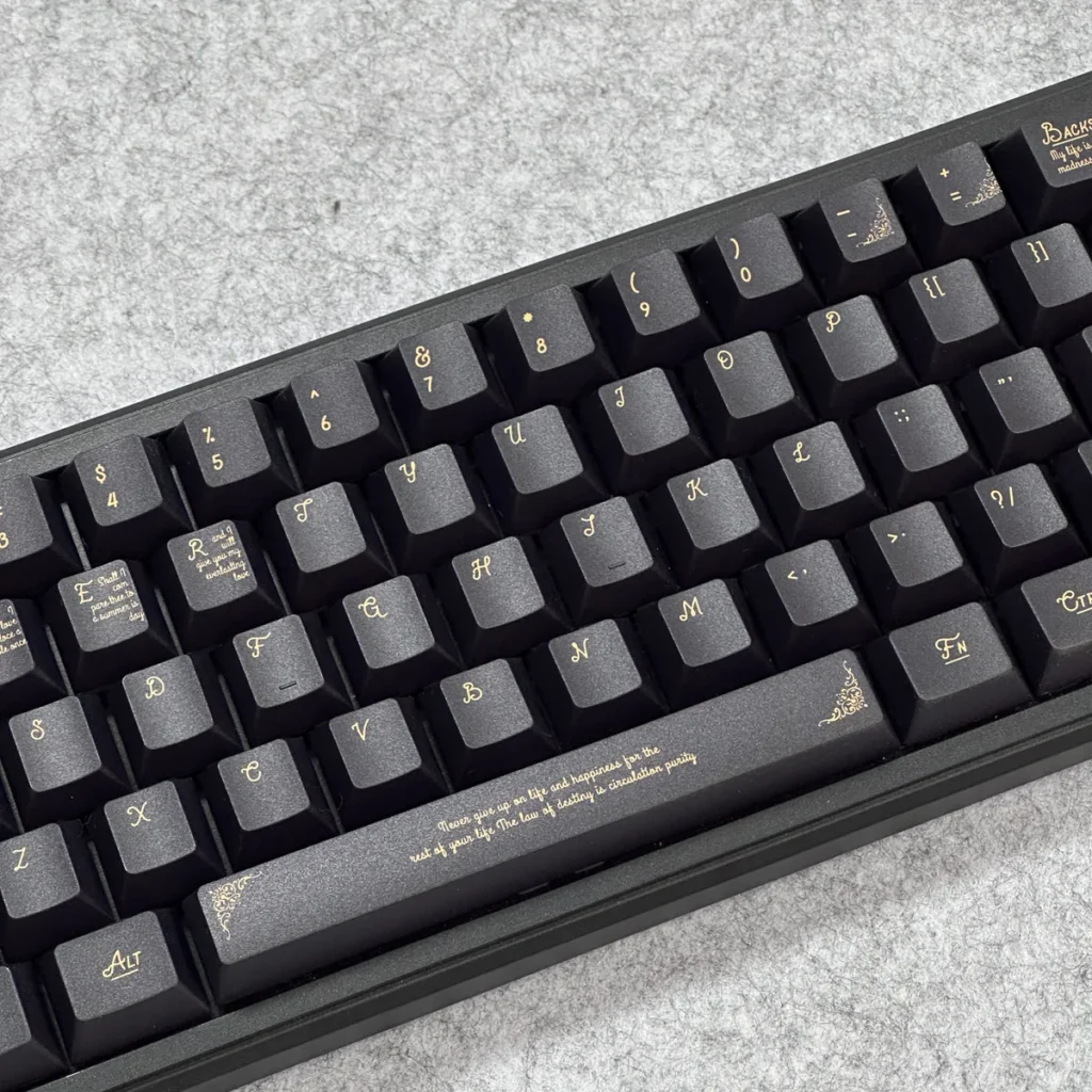 Side profile view of the Black Gold Baroque keycaps, showcasing the ergonomic Cherry profile.