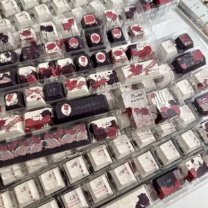 Artistic shot of Dark Rose Keycap Set packaging with rose motifs