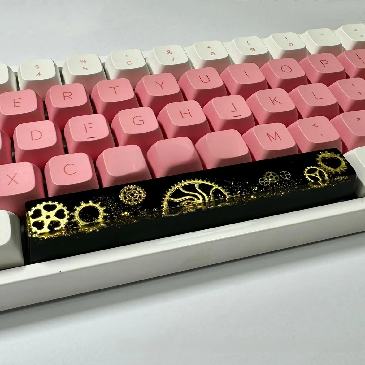 Close-up of the Gear Spacebar Keycap showcasing transparent resin and detailed internal gears.