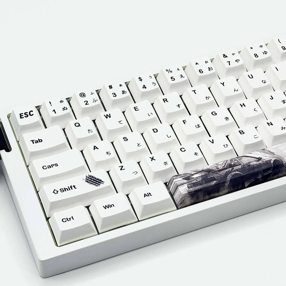 Close-up of Initial D AE86 keycaps featuring racing details