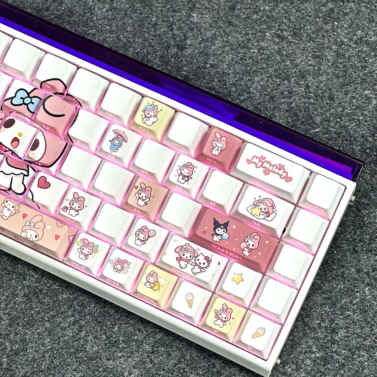 Detailed view of My Melody keycaps illuminated by keyboard backlight, highlighting the unique side legends