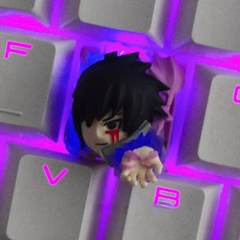 Close-up of handcrafted Sasuke Uchiha keycap detailing and translucent resin