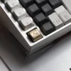 Artisan whale keycap made from solid brass, reflecting light beautifully