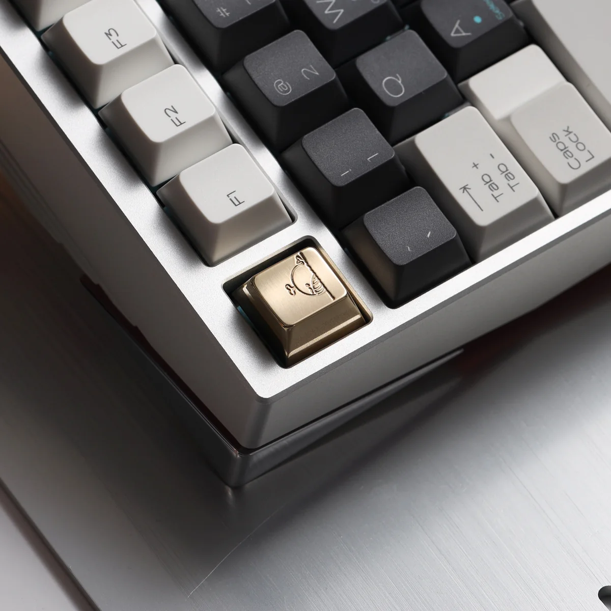 Artisan whale keycap made from solid brass, reflecting light beautifully