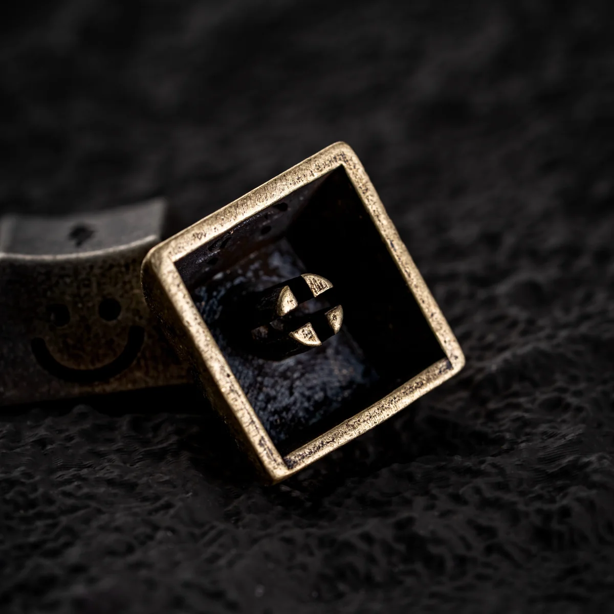 Brass variant of the handcrafted luminous lightning keycap on a dark background