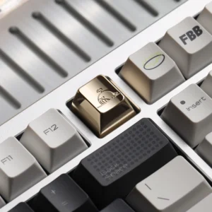 Brass Whale Keycap with mirror-polished finish on a mechanical keyboard