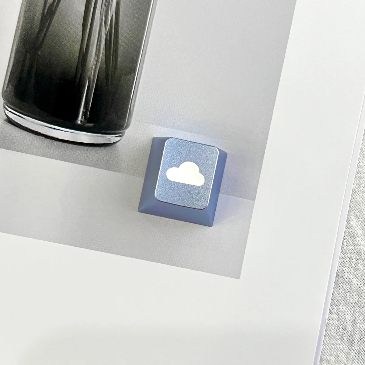 Close-up of CNC machined aluminum cloud texture on keycap