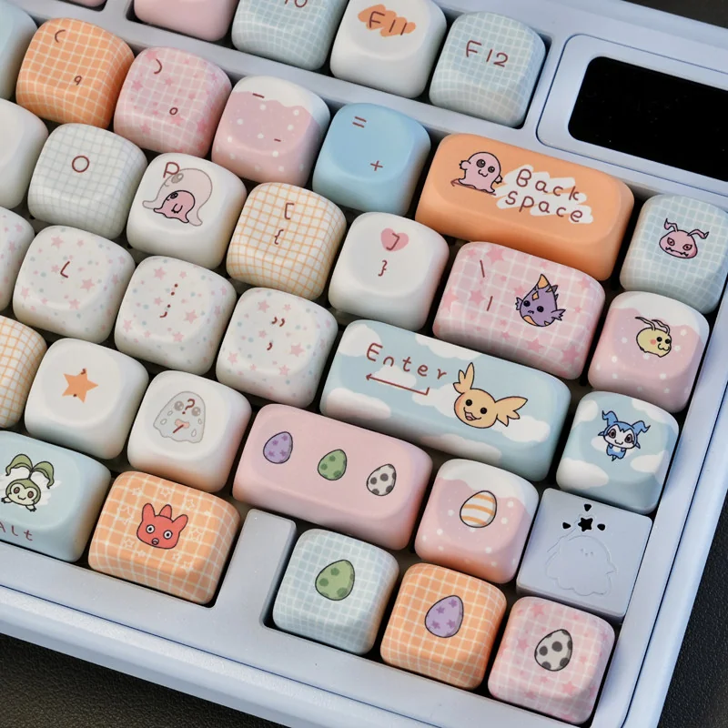Detailed shot of various Digimon character keycaps, emphasizing the crisp legends and rich colors.
