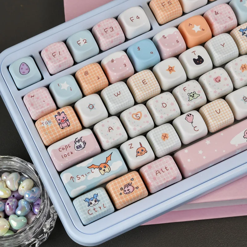Close-up of Digimon keycaps, highlighting five-sided dye-sublimation and PBT texture.