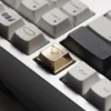 Close-up of handcrafted brass whale keycap showing intricate details