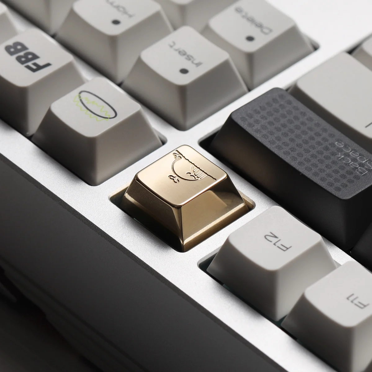 Close-up of handcrafted brass whale keycap showing intricate details
