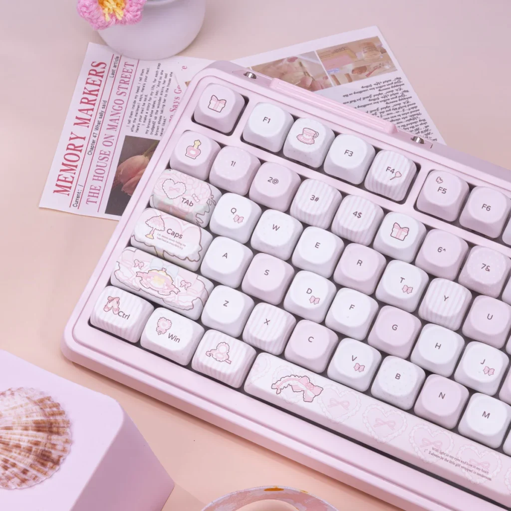 Close-up of pastel pink PBT keycaps with dye-sublimated legends, highlighting the smooth texture and color accuracy.