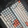 Close-up of salmon-themed PBT keycaps showcasing dye-sublimated legends