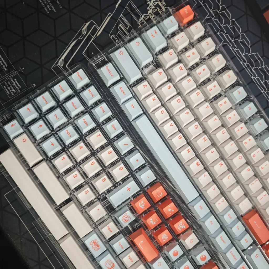 Close-up of salmon-themed PBT keycaps showcasing dye-sublimated legends