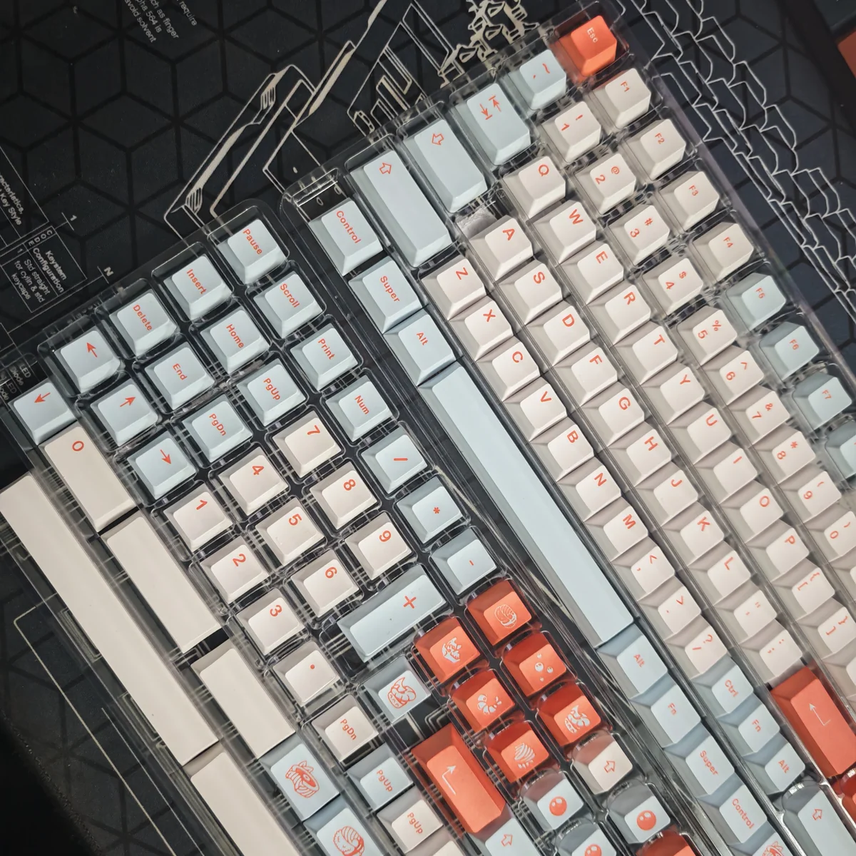 Close-up of salmon-themed PBT keycaps showcasing dye-sublimated legends