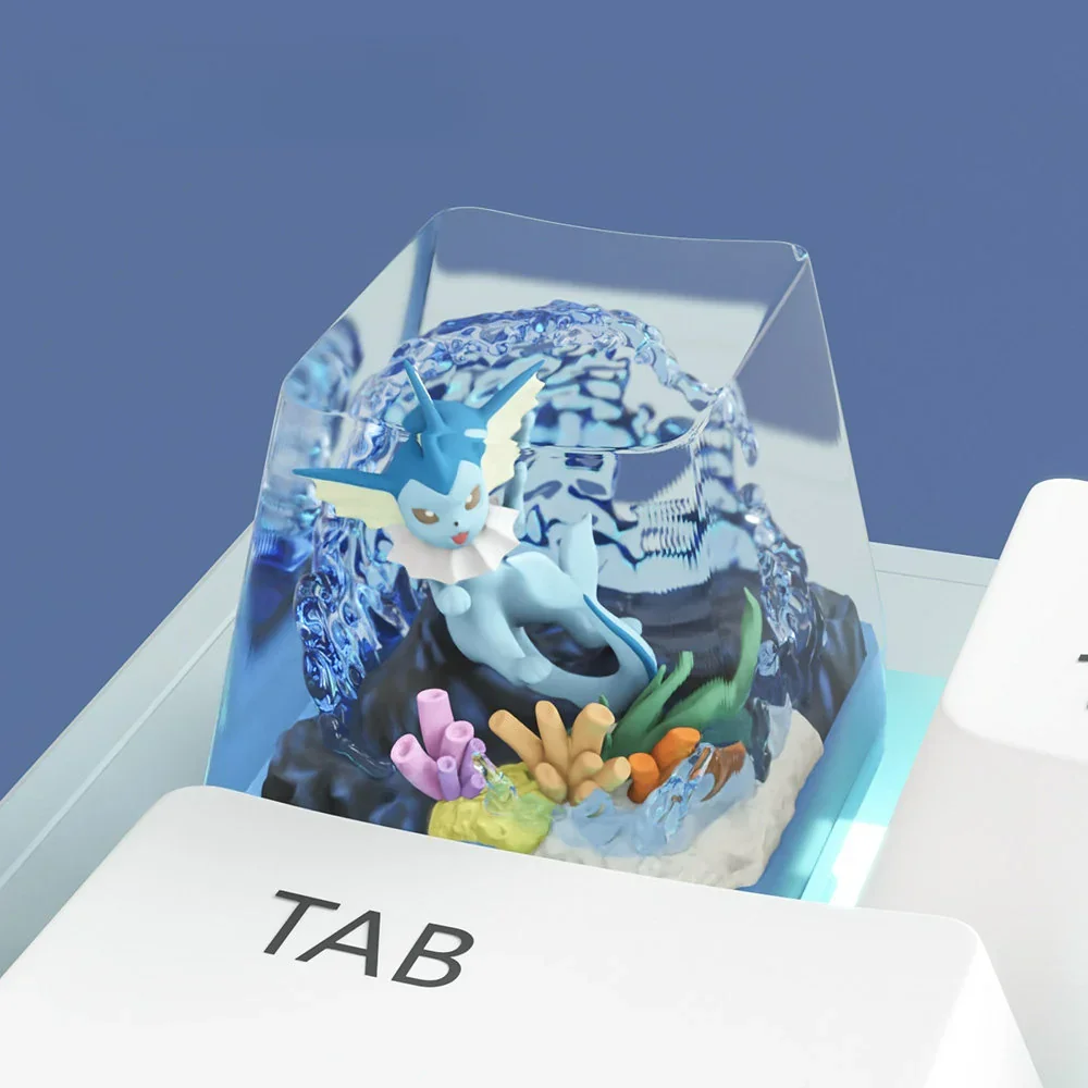 Desk setup featuring the Vaporeon artisan keycap as a unique accent, beside other Pokemon themed items