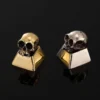 Artisan's hands meticulously detailing a skull keycap during the crafting process.